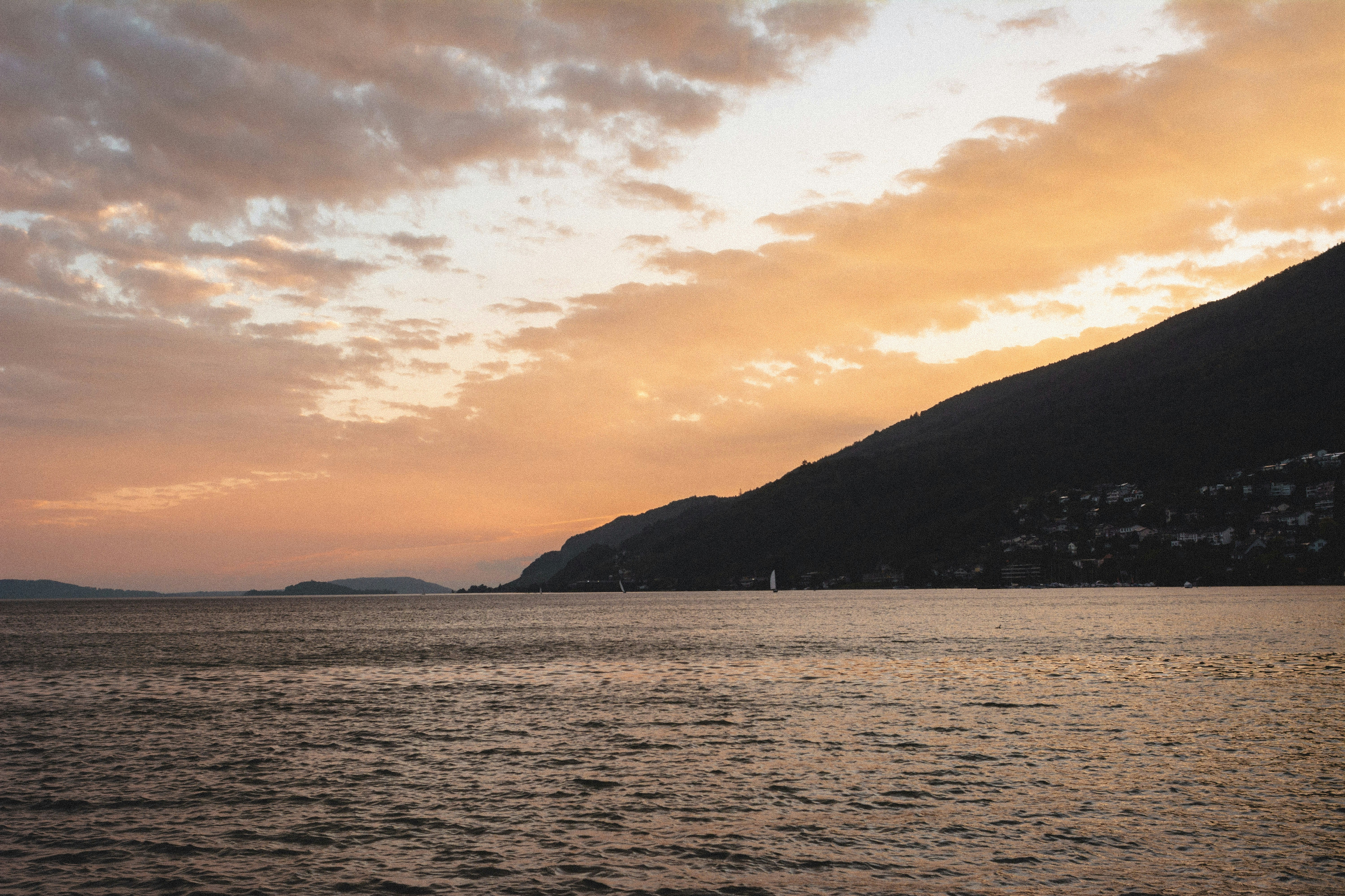 a body of water with a mountain in the background