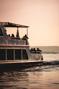 A vibrant photo of travelers enjoying a boat trip around the Komodo islands at sunset.