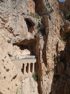 The dramatic cliffs of Barrancas del Cobre with a train winding through the canyon.