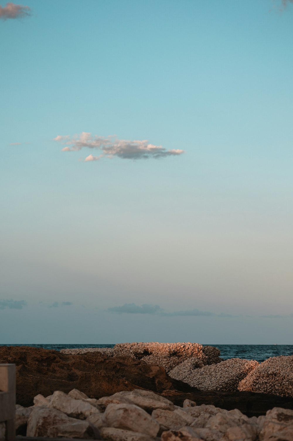 a person sitting on a bench looking out at the ocean