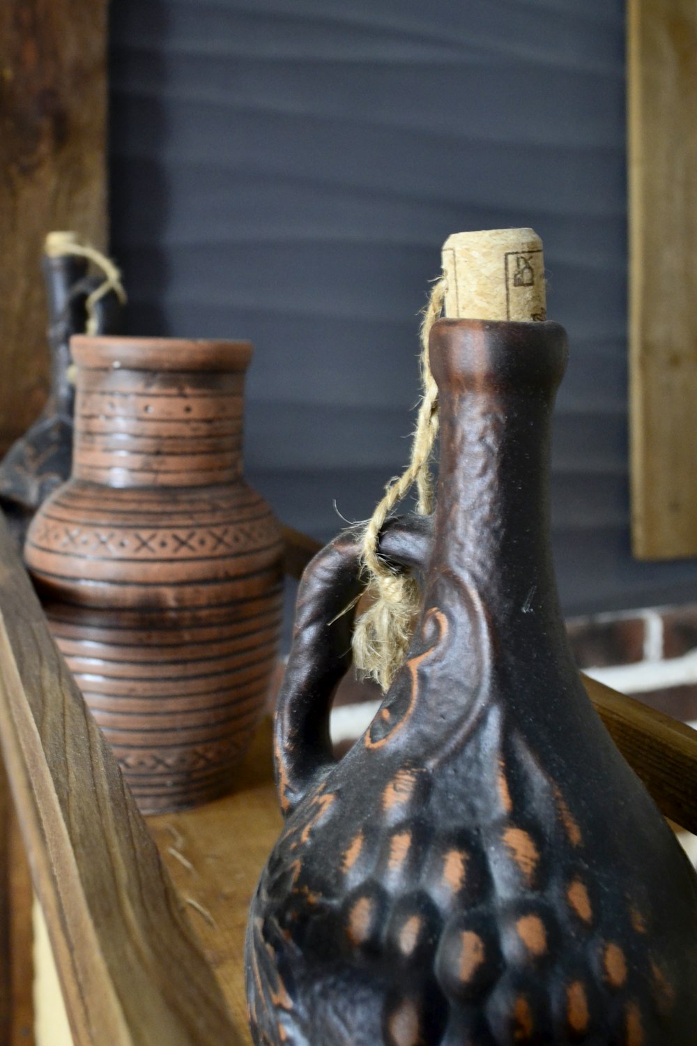 a couple of vases sitting on top of a wooden table