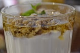 A close-up of a dessert bowl topped with fresh fruit and a drizzle of honey.