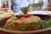 Close-up of steaming cooked sona masuri rice served in a rustic bowl.