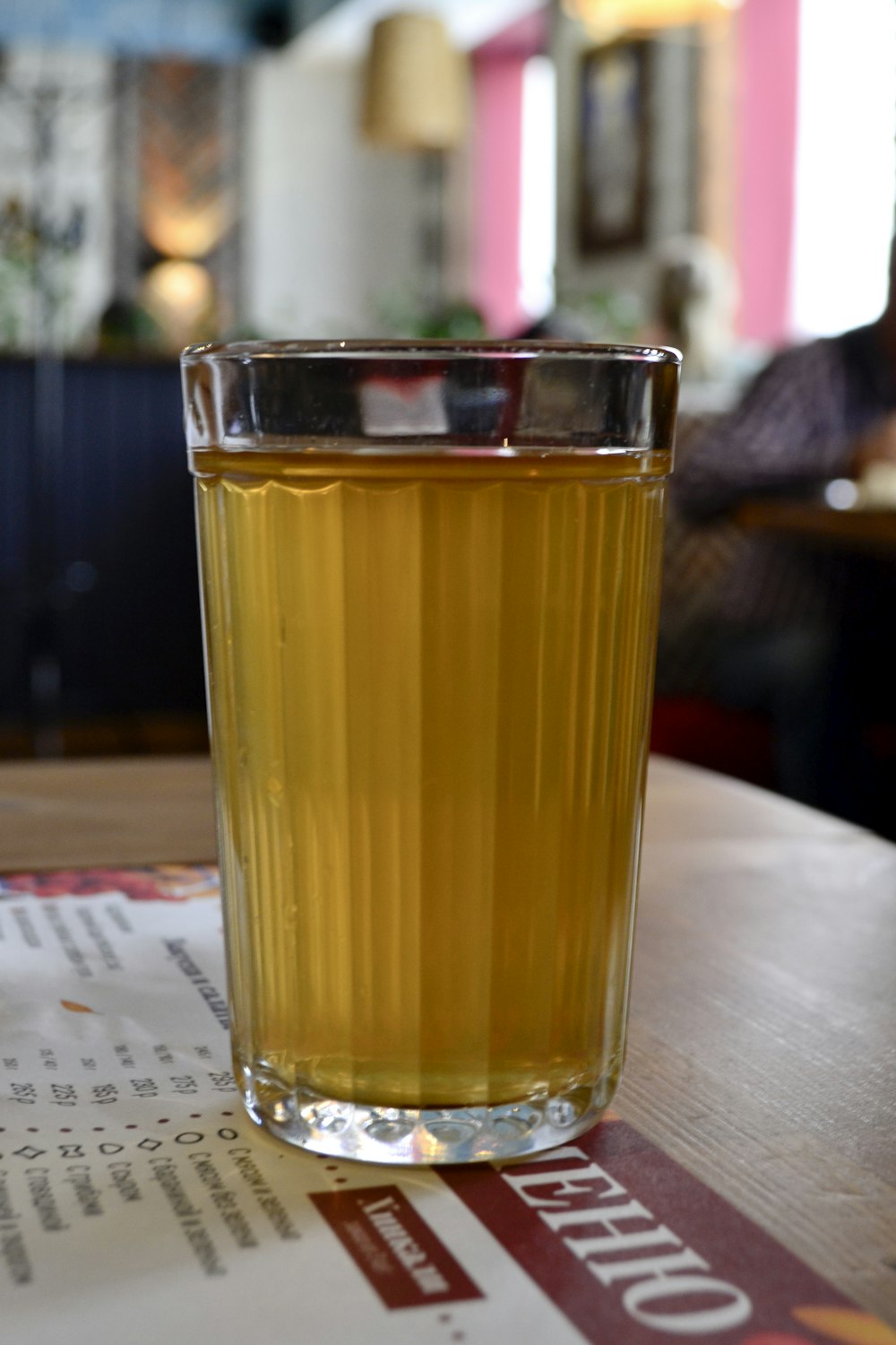 a glass of liquid sitting on top of a table