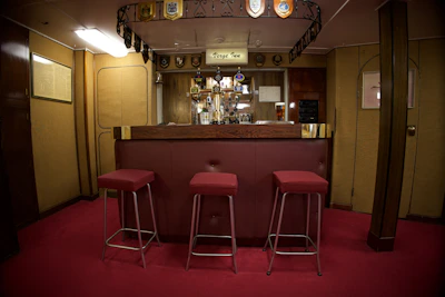 A welcoming bar area featuring a selection of real ales and warm lighting.