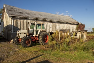 a tractor parked in front of a barn