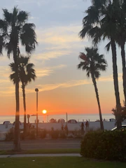 Behind-the-scenes shot of the crew filming a sunset beach scene.