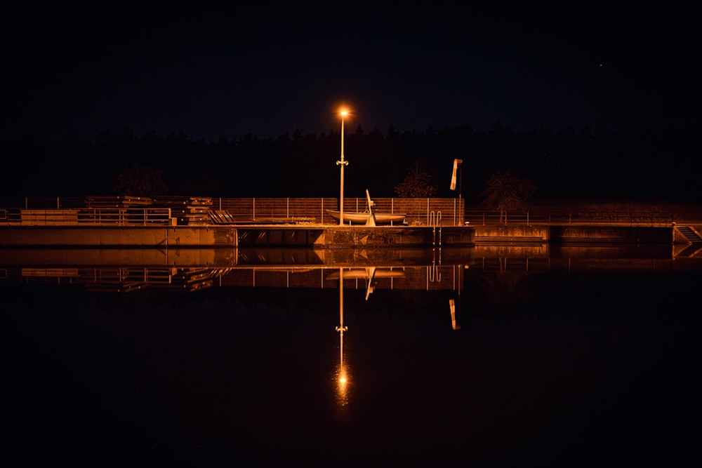 a boat is docked at a dock at night