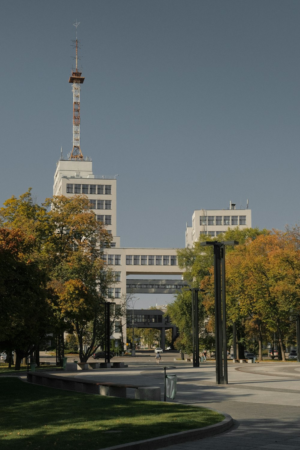 a large white building with a tower in the background