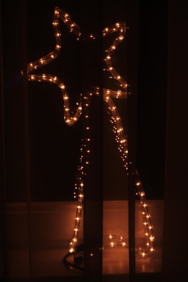 LED angel figure glowing in a dimly lit festive setting.