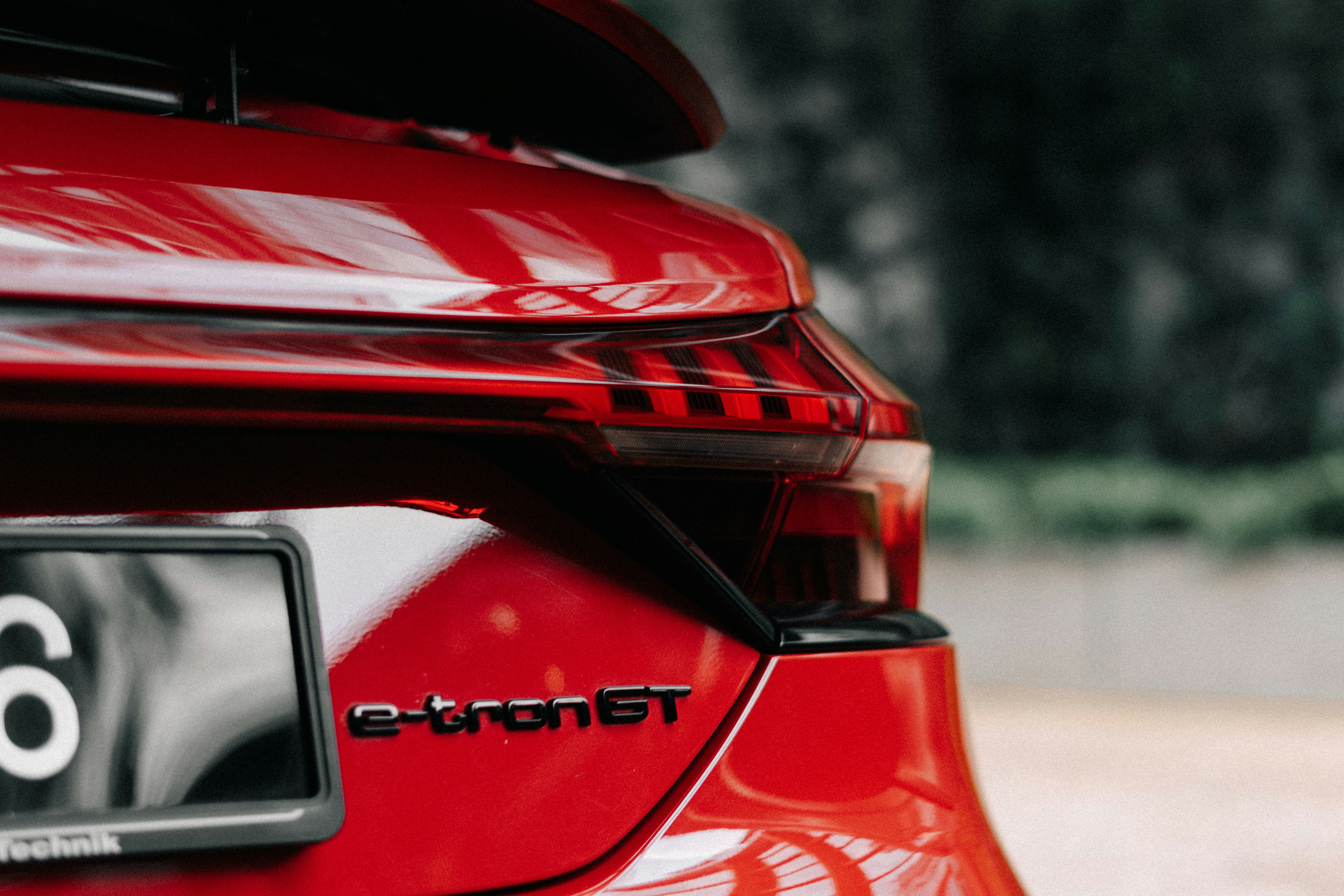 the rear end of a red car with the number six on it