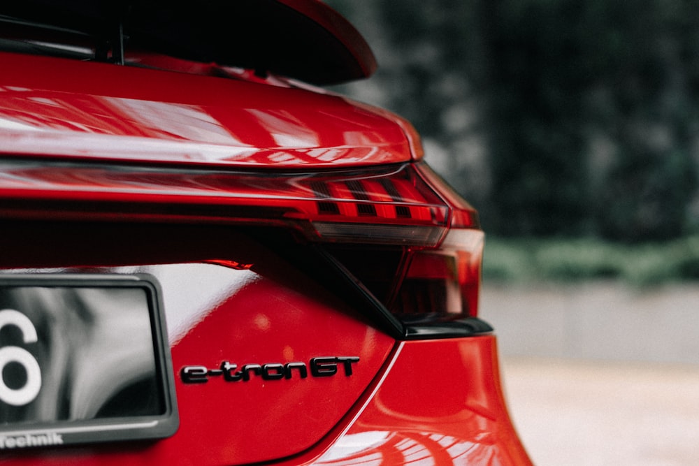 the rear end of a red car with the number six on it