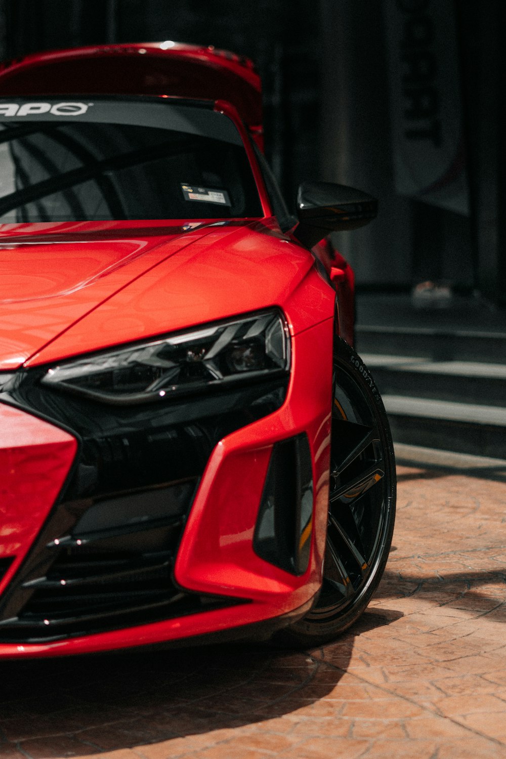 a red sports car parked in front of a building