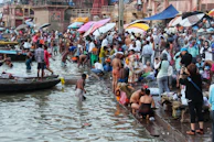 The serene ghats of Varanasi with pilgrims performing evening rituals by the river.