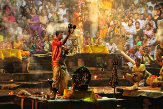 An experienced priest performing a traditional puja ritual with focused reverence and vibrant flowers around.