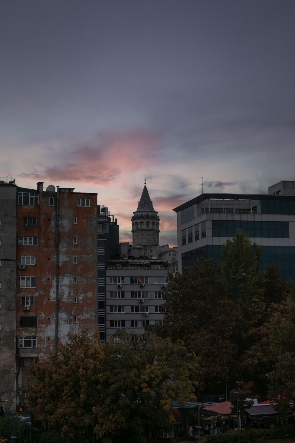 a city with tall buildings and a clock tower