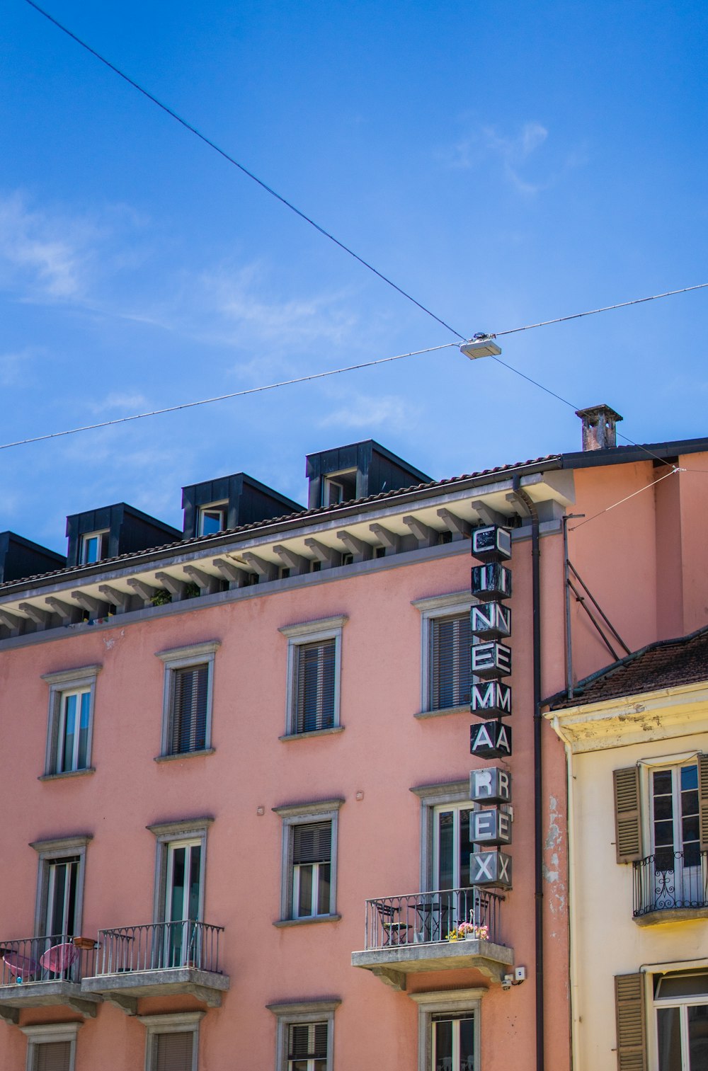 a pink building with a sign on the side of it