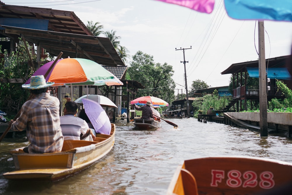 a group of people riding on top of a boat down a river