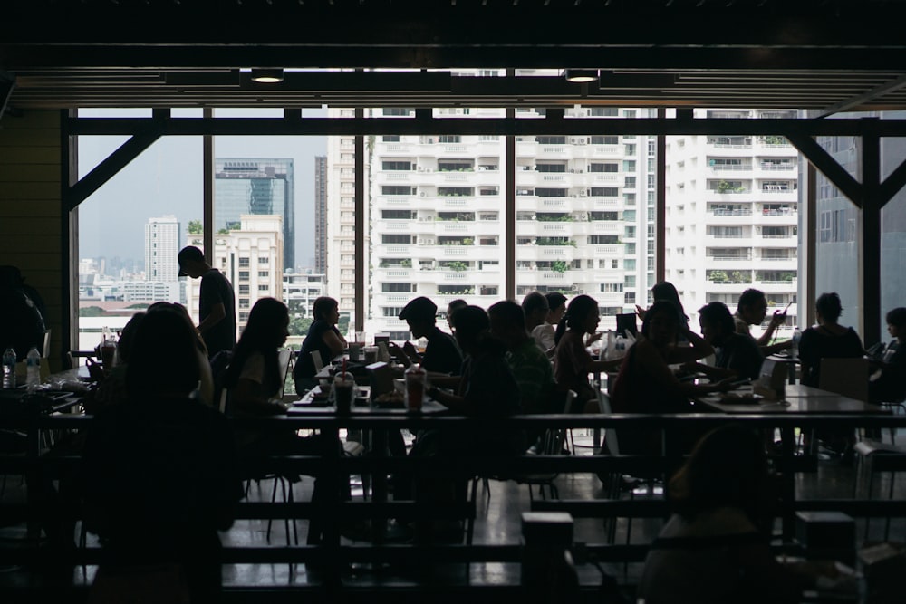 a group of people sitting at tables in a restaurant