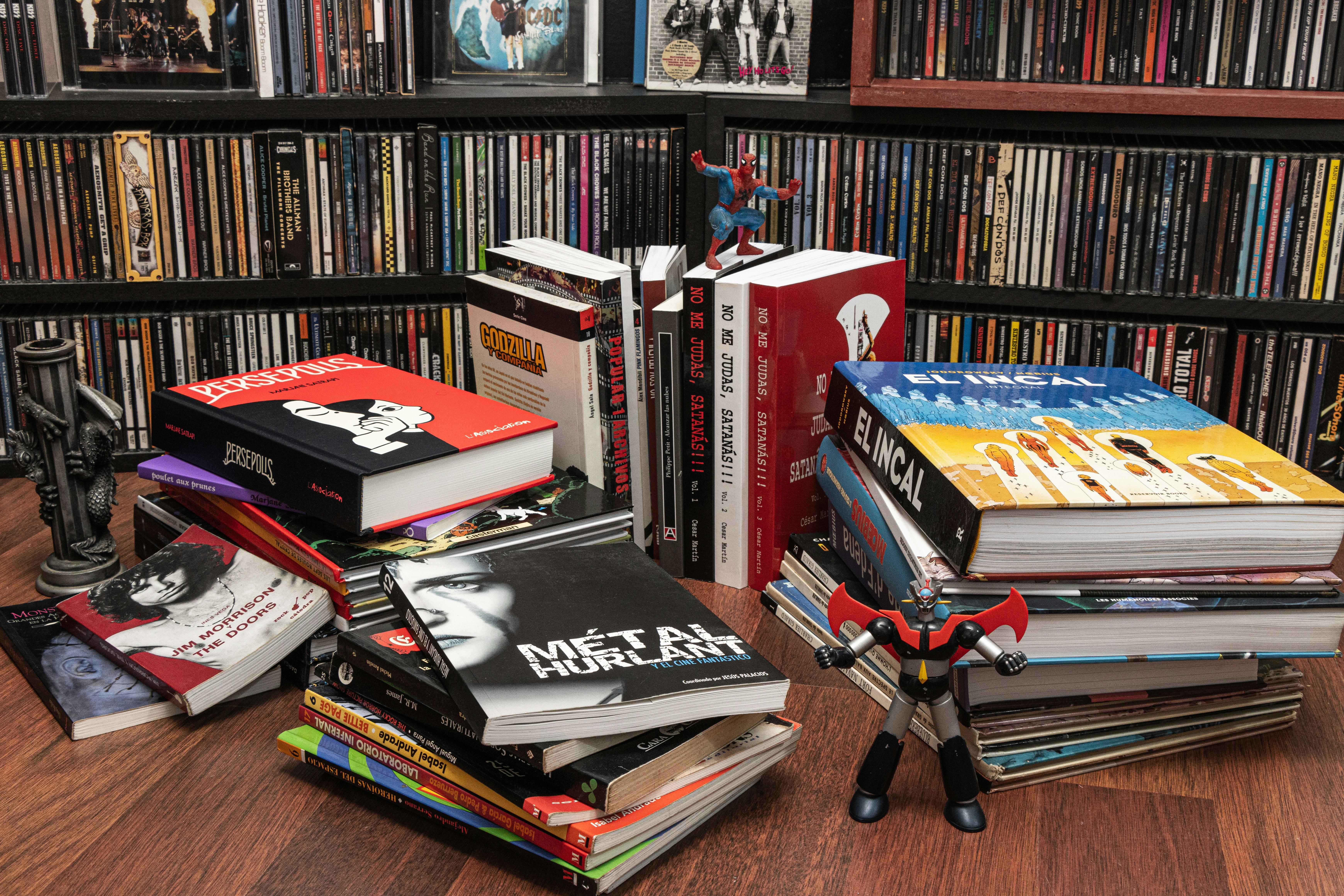 How to Build a Movie Collection Without Cluttering Your Space – a pile of books sitting on top of a wooden table