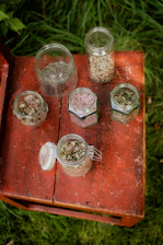 Close-up of dried herbs and essential oils arranged on a wooden table.