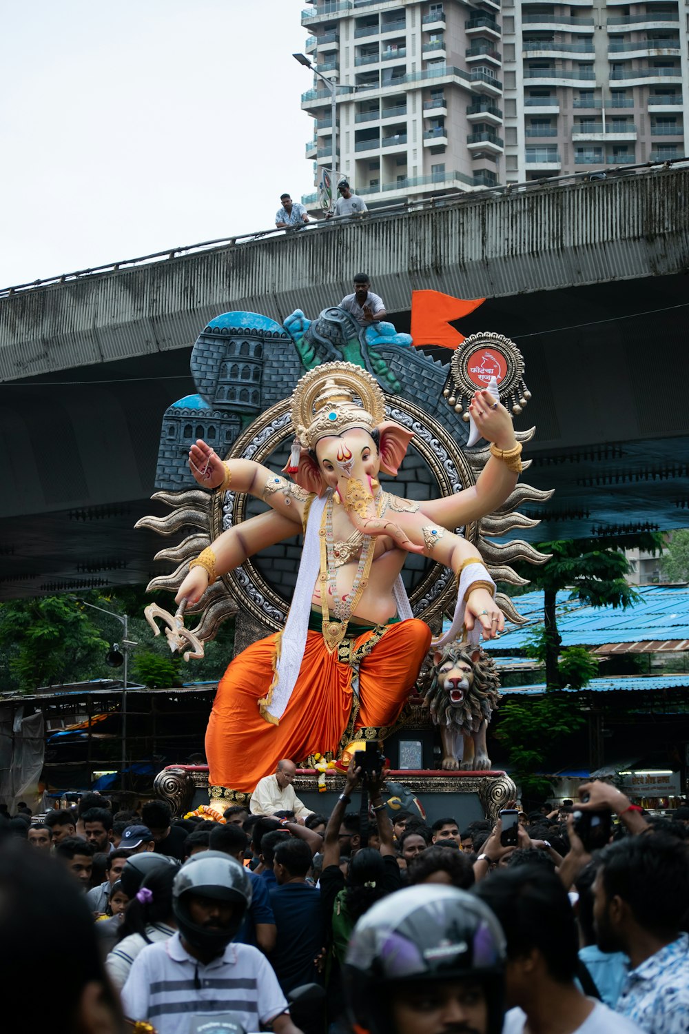 a large statue of a hindu god in the middle of a crowd