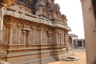 Intricate carvings on an ancient Indian temple wall bathed in warm sunlight.