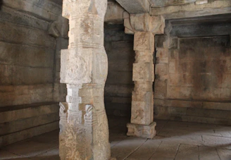 A dimly lit ancient stone structure with mysterious carvings glowing faintly.