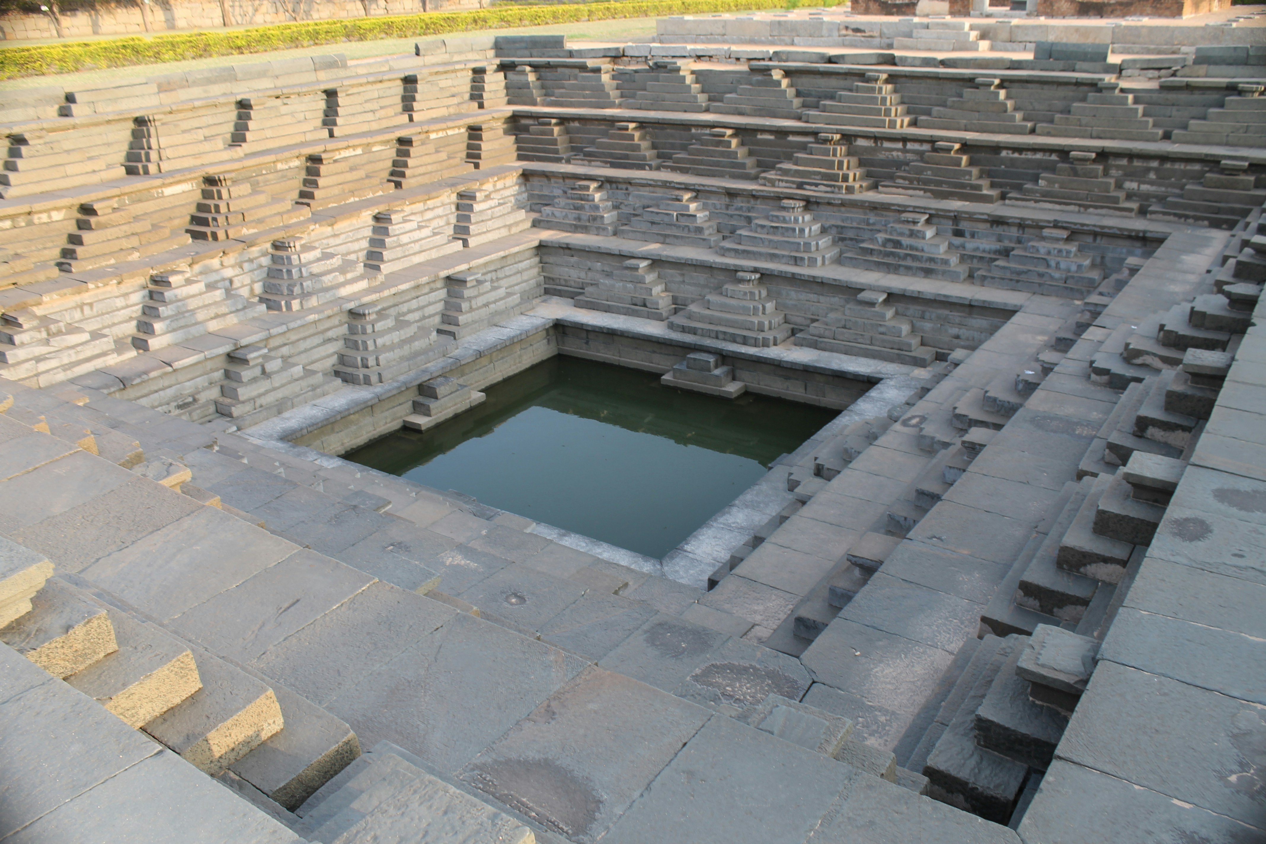 a large pool of water surrounded by stone steps