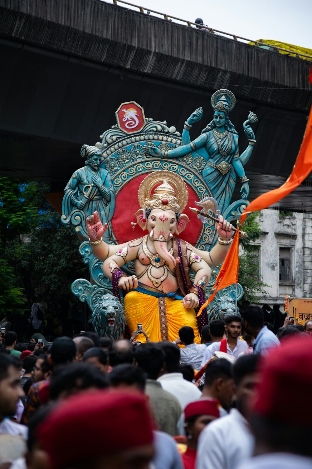 a large statue of a hindu god in a crowd of people