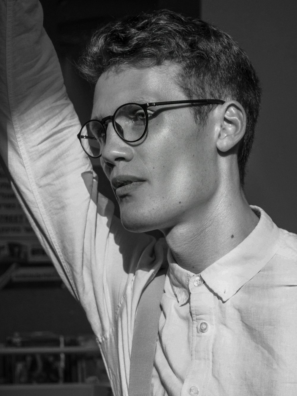 a man wearing glasses and a white shirt