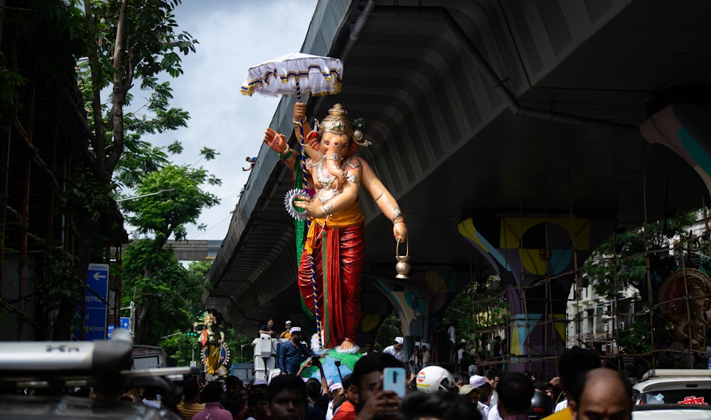 a large statue of a person holding a lamp