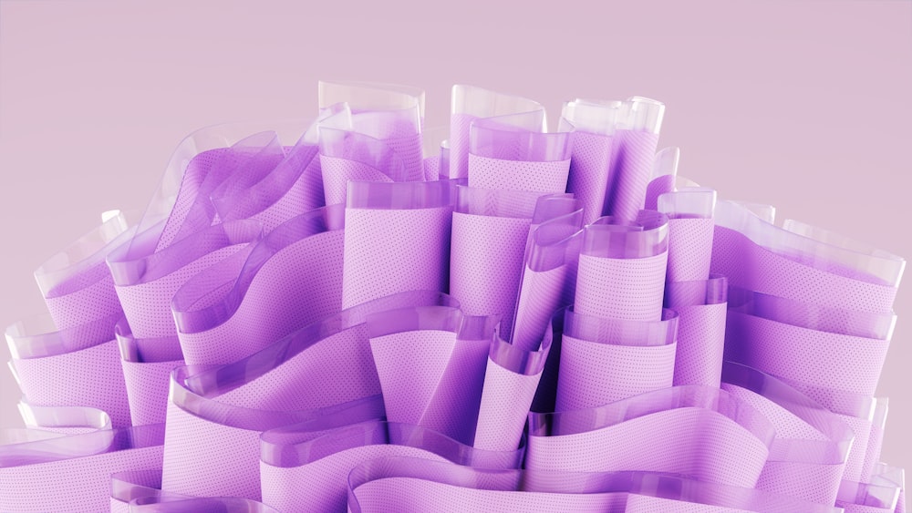 a pile of purple plastic cups sitting on top of a table