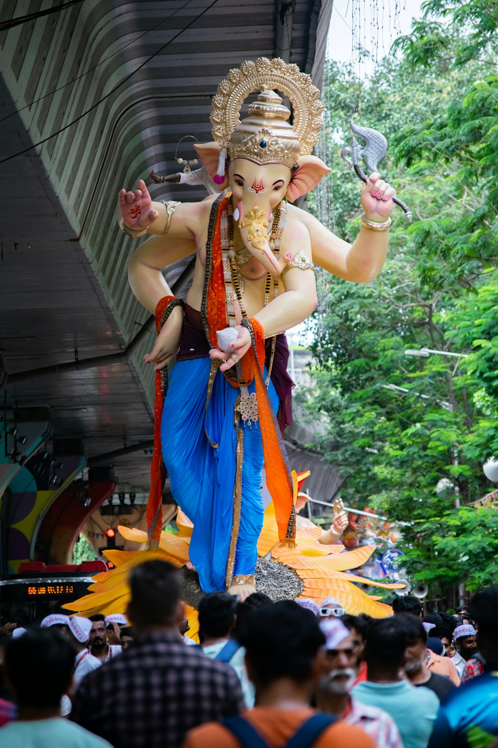 a large statue of a man holding a glass of wine