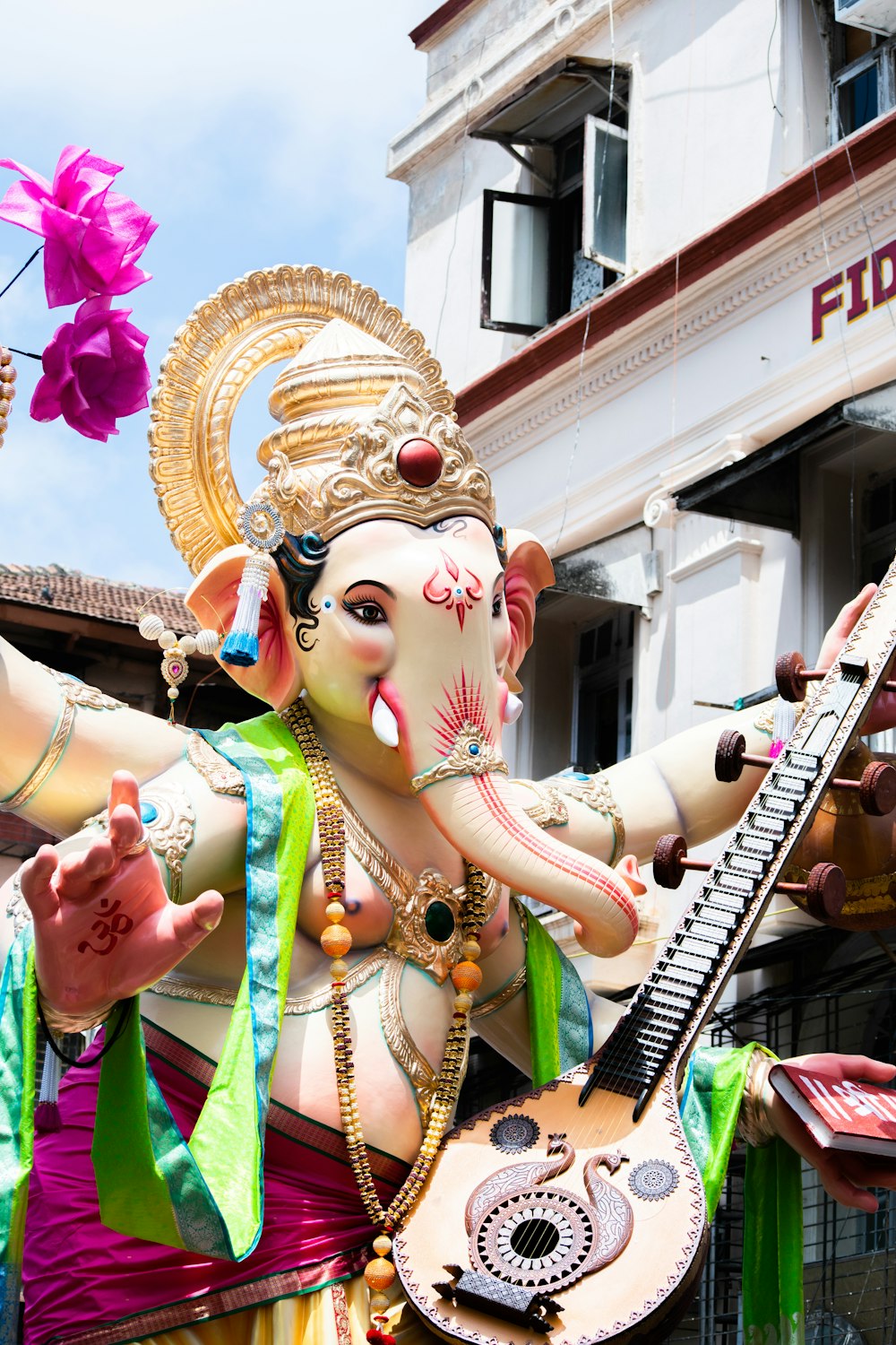 a statue of an elephant playing a guitar