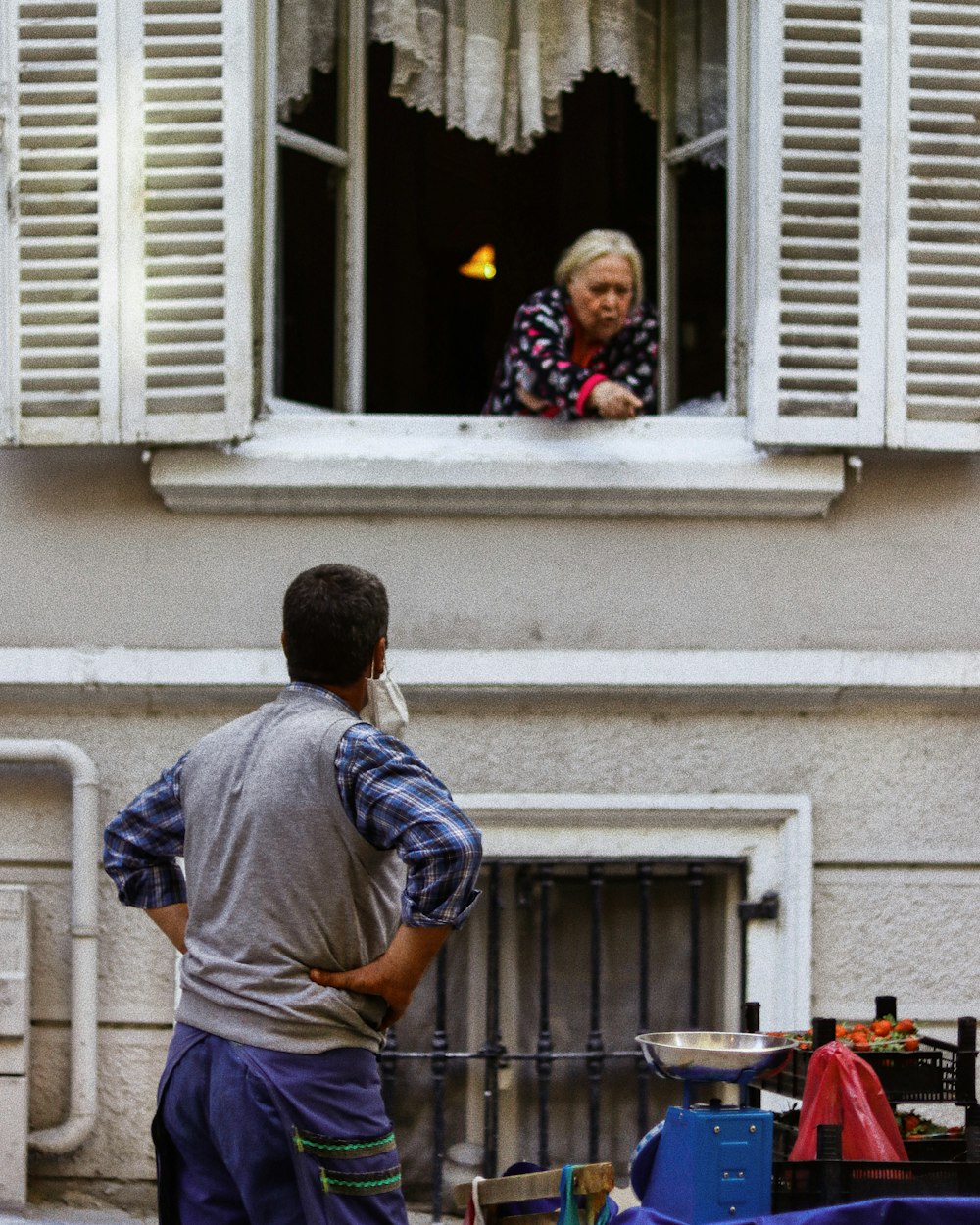 a man and a woman looking out of a window