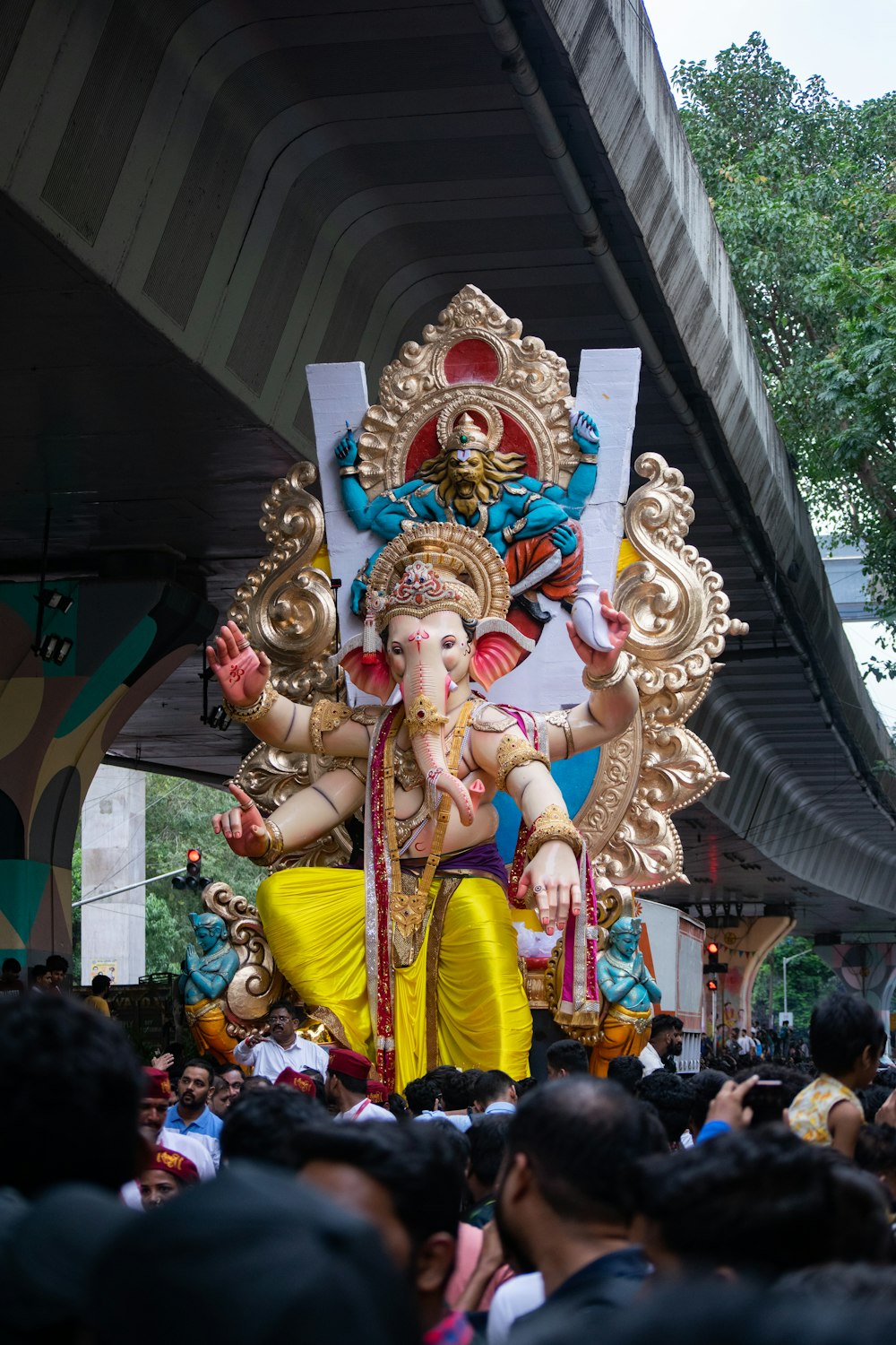 a large statue of a hindu god in front of a crowd