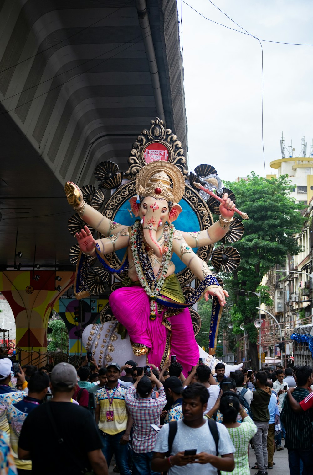 a large statue of a god on a city street
