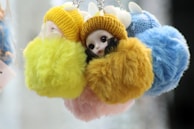 A close-up of puffyfinds’ most loved plush accessories resting on a soft knitted throw.