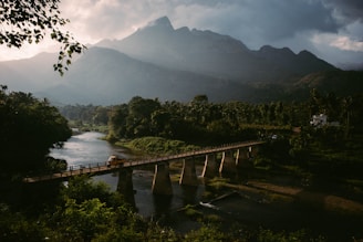 A scenic view of a truck crossing a bridge with the American landscape in the background.
