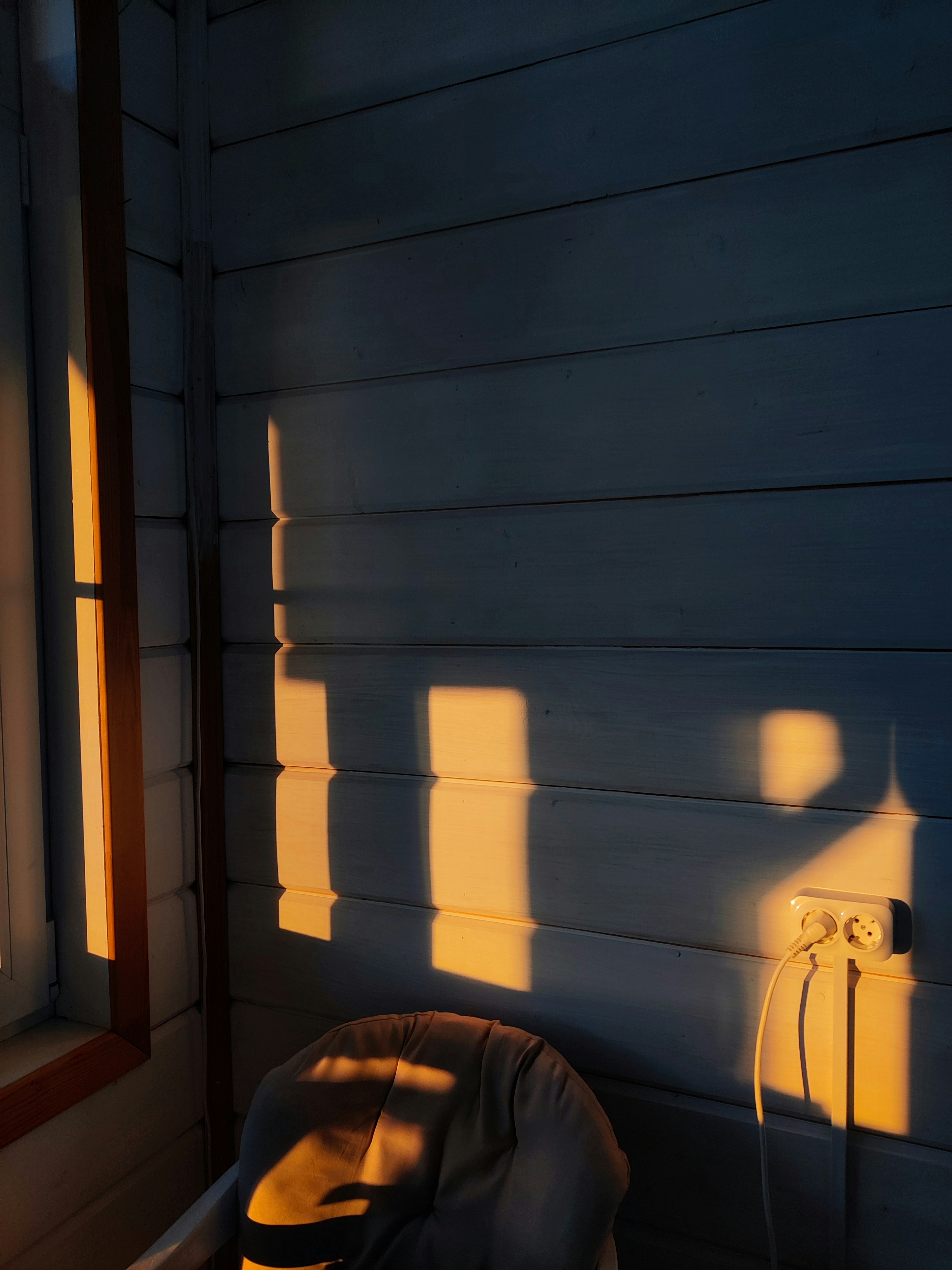 a chair sitting next to a window in a room