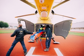 a man is being loaded into the back of a helicopter