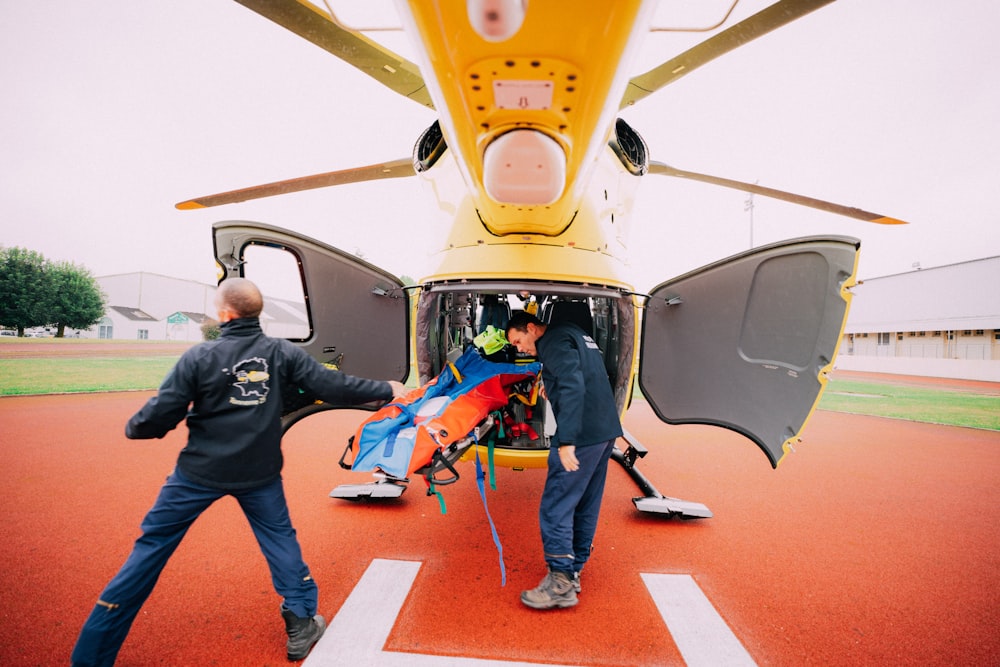 a man is being loaded into the back of a helicopter
