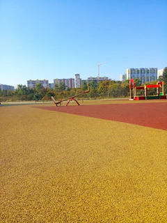 Bright and colorful playground area with children playing and families enjoying the space