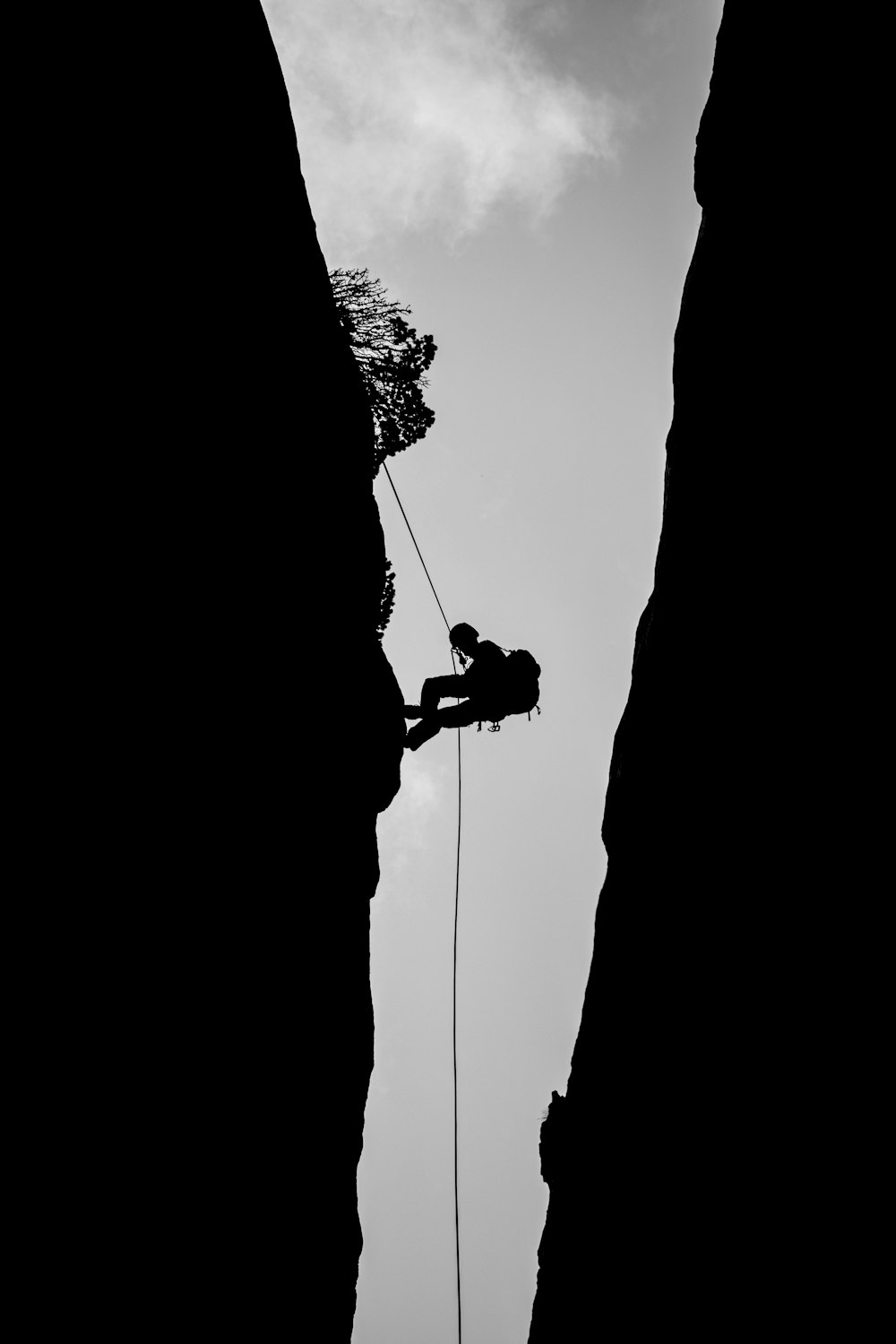 a man climbing up the side of a mountain