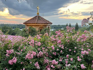 A serene sunrise over a quiet chapel garden, symbolizing new spiritual beginnings.