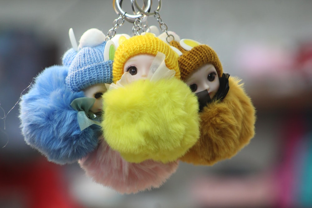 a couple of stuffed animals hanging from a key chain