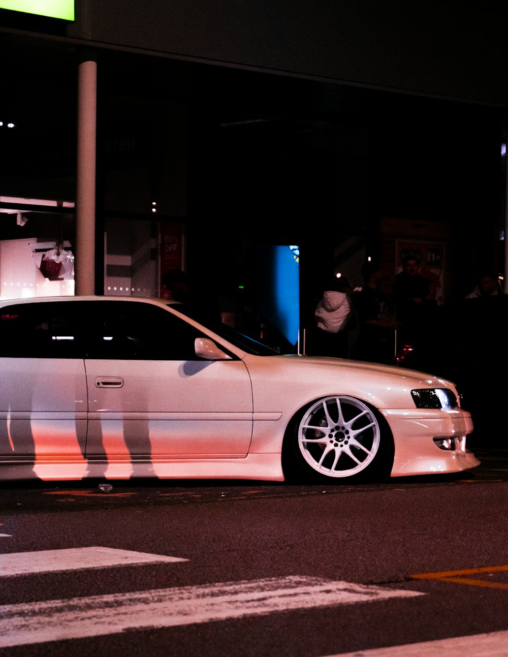 a white car parked on the side of the road