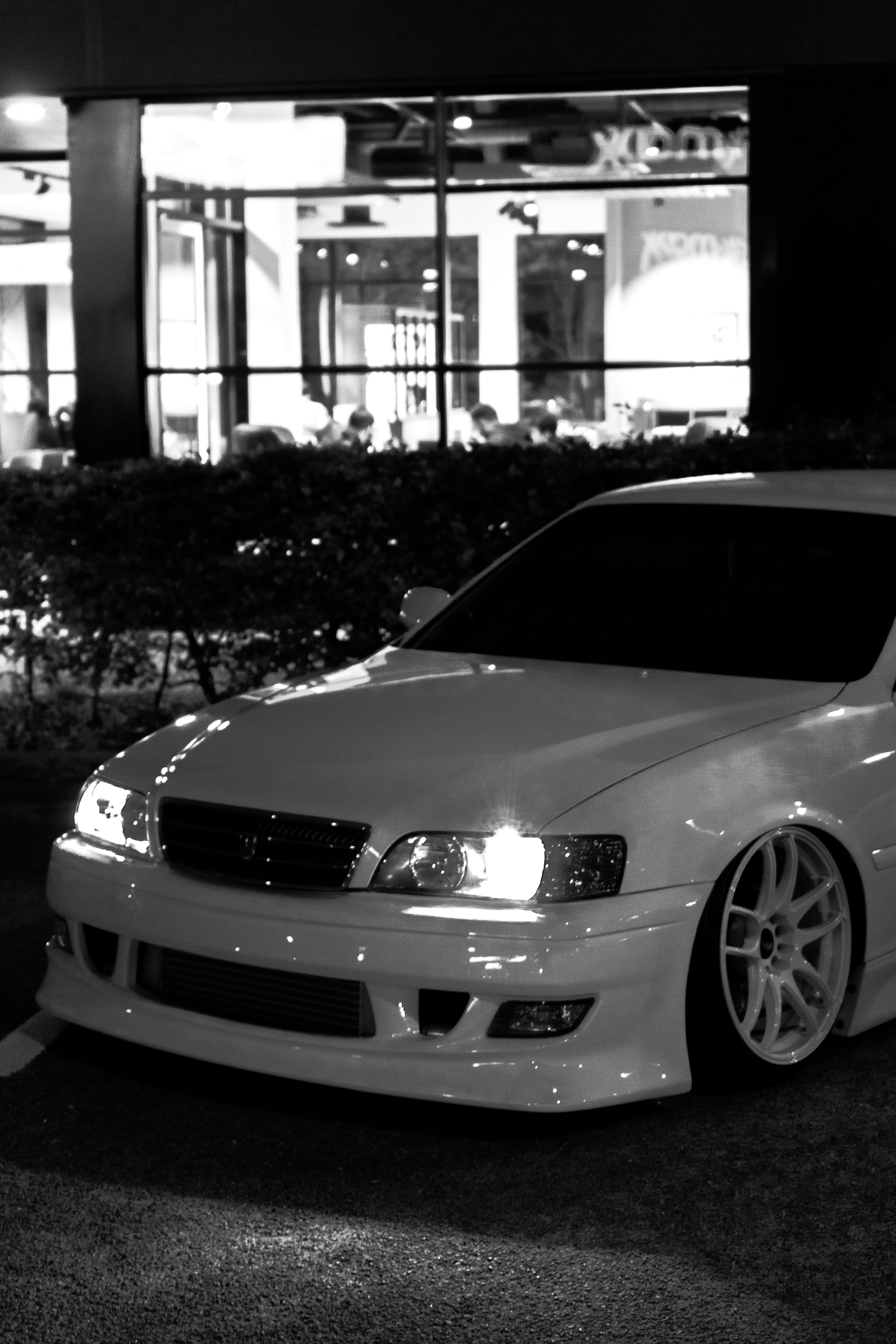 a white car parked in front of a building
