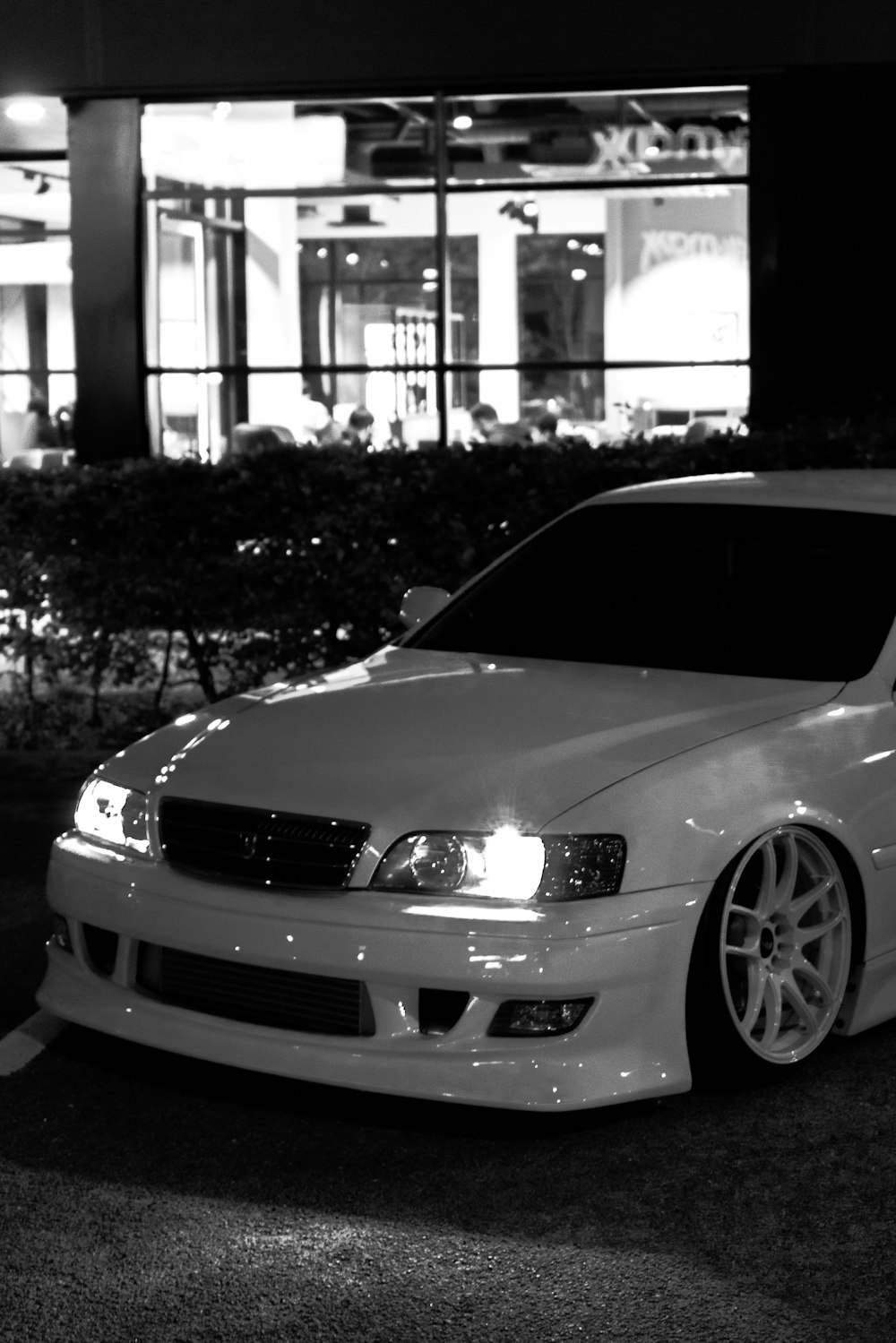 a white car parked in front of a building